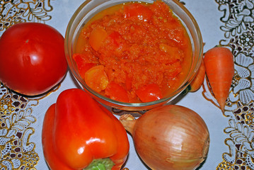 Proper and healthy vegetable diet. Delicious fresh cooked salad of carrots, tomatoes, onions and peppers in a plate on the table.