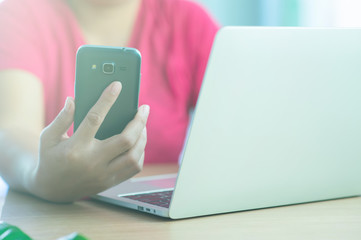 Asians buy products online using notebooks and mobile phones. - Images