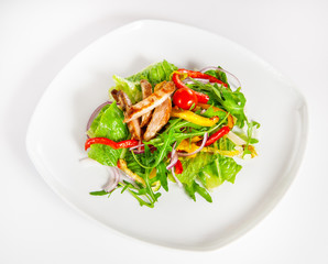 Delicious salad with meat, tomatoes and greenery on white