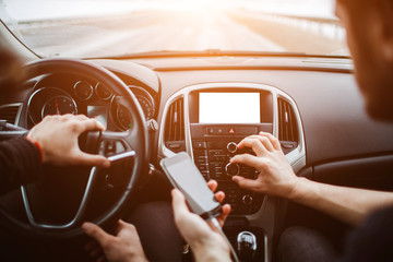 The man presses buttons . On the background of the car.