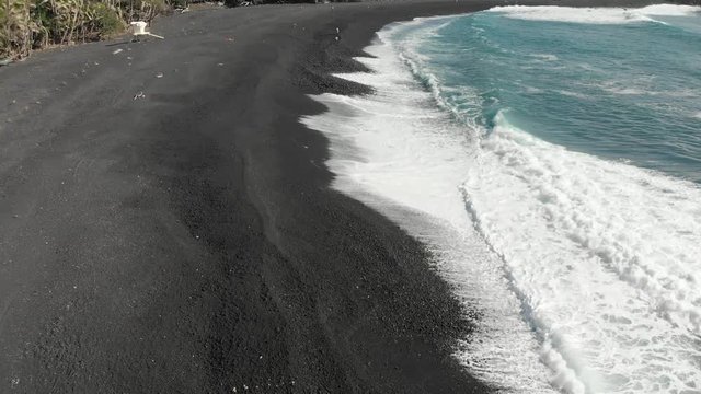 A close up aerial of Pohoiki's black sand beach made from the shards of the recent lava flow in puna Hawaii.