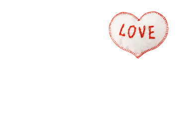 small soft homemade toy in the form of a heart for Valentine's Day on a white isolated background