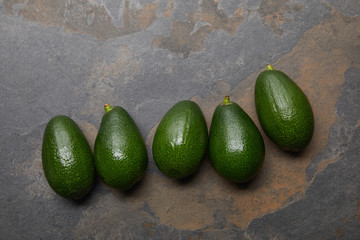 top view of avocados on grey background