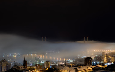 Fototapeta na wymiar Vladivostok cityscape night view. Fog over the city.