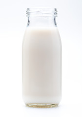 Milk in glass bottle. Without lid. Isolated on white background.