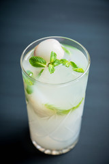 Fresh lychee mojito on the rustic background. Selective focus. Shallow depth of field. 