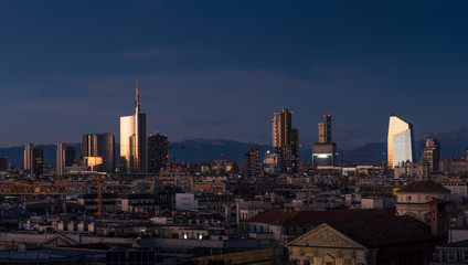Aerial view of Milan skyline at sunset with alps mountains in the background. - 246615721