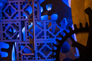 Abstract, colorful and blurry shot of steam punk gears and mechanisms. Rotating home decor and ornaments on wall