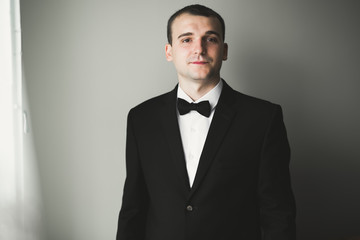 Portrait of happy businessman standing in studio