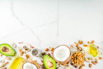 Healthy vegan fat food sources, omega3, omega6 ingredients - almond, pecan, hazelnuts, walnuts, olive oil, chia seeds, avocado, coconut,  banner copy space