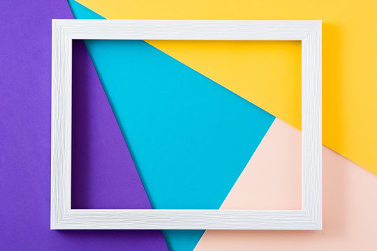 White Wooden Frame On Colorful Background. Copyspace. Mockup.

