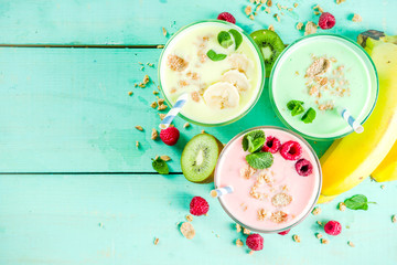 Summer refreshing drinks - protein shakes, milkshakes or smoothies, with fresh berry and fruits, light blue table copy space