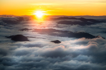 sunrise and sea of fog view on phu chi fa mountain area and national forest park in chiang rai,...