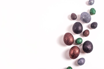 Brilliant Easter eggs in glitter of different colors on a white background.