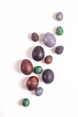 Brilliant Easter eggs in glitter of different colors on a white background.