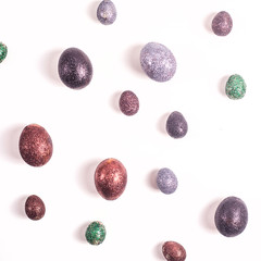 Brilliant Easter eggs in glitter of different colors on a white background.