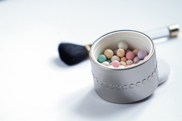 colored powder balls on white background