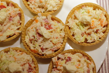Obraz na płótnie Canvas home made pintxos with crab meat and eggs and mayones sause in tartlet, traditional spanish snack 