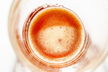 Wheat-colored alcoholic beer drink in a glass close-up with a slight froth on the surface suitable for summer parties refreshes perfectly.