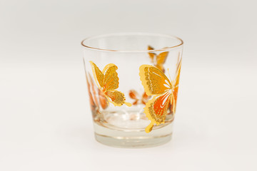 short drinking glassware that has butterlies painted on them