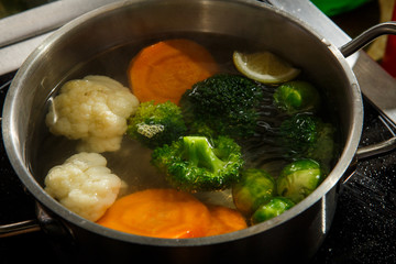boiled vegetables lie in water in metal vessel