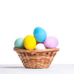 Fototapeta na wymiar Basket with painted Easter eggs, isolated