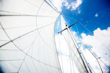 Close-up view of the mast and sails against cloudy blue sky. Baltic sea, Estonia