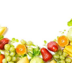 flat lay top view tropical fruits frame background: grape, rose apple, orange, spinach, mango, pear, guava and banana. Healthy drink ingredients. Vegetarian, vegan food concept. Detox. Text space