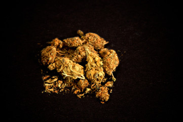 pile of medicinal marijuana on black background. Used as a recreational drug and also alternative medicine.