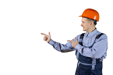 A civil engineer in an orange helmet looks to the side and points at something. isolated