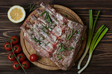 pork ribs with cherry on a dark wooden background
