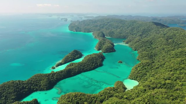 Aerial view of South Rock Islands (Chelbacheb), many lush green islets around Ngeruktabel island, seascape with colorful coral reefs and lagoons - landscape panorama of Micronesia from above, Palau