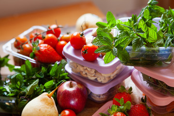 Filled plastic containers to save food, herbs and fruits fresh, concept of economy household