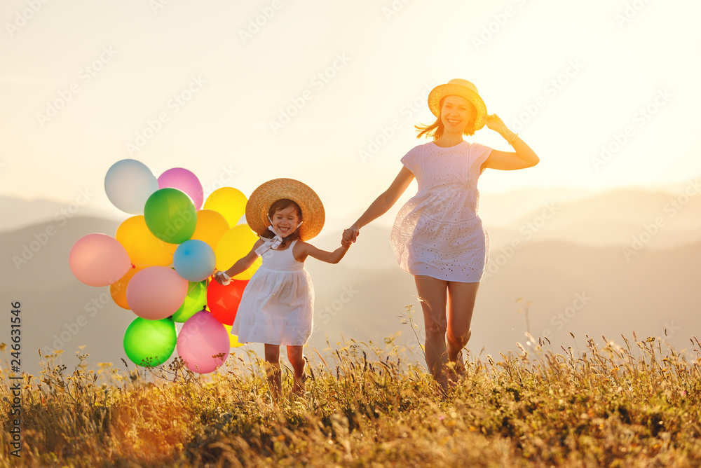 Canvas Prints happy family mother and child with balloons at sunset in summer.