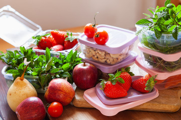Filled plastic containers to save food, herbs and fruits fresh, concept of economy household