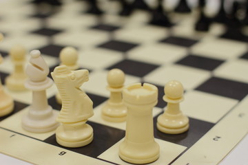set of chess on a board, ready for competition, white and black set, king, queen, horse figures