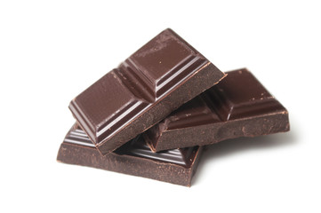 closeup of chocolate blocks pile on white background