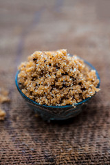 Close up of popular Indian & Asian sweet dish i.e. Malida or churma na ladu or moti chur na ladu in a bowl on brown surface.