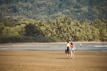 young couple walking on the Uvita beach Costa Rica 