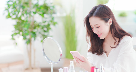woman makeup and use phone