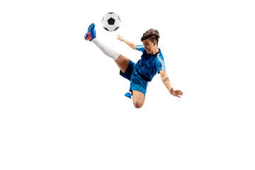 Young boy with soccer ball doing flying kick, isolated on white. football soccer players in motion on studio background. Fit jumping boy in action, jump, movement at game. - obrazy, fototapety, plakaty