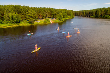 More SUP-surfers on river in forest