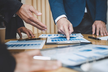 Executive team discussing the charts and graphs working in business strategy and financial plan to investment profit, discussing working analysis with financial data and marketing growth report