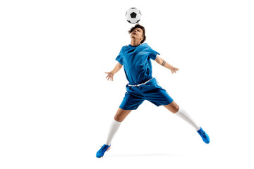 Fototapeta na wymiar Young boy with soccer ball doing flying kick, isolated on white. football soccer players in motion on studio background. Fit jumping boy in action, jump, movement at game.