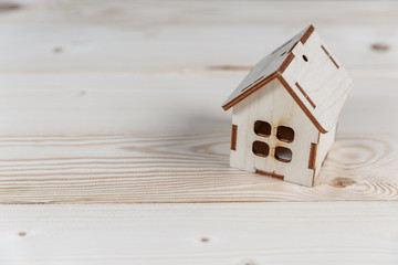 Obraz na płótnie Canvas Real estate concept. Small toy wooden house with keys