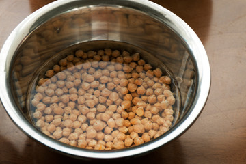 Chickpeas soaking in a water bowl - cooking hummus