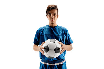 Young fit boy with soccer ball standing isolated on white. The football soccer player on studio...