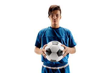 Young fit boy with soccer ball standing isolated on white as winner. The football soccer player on studio background.