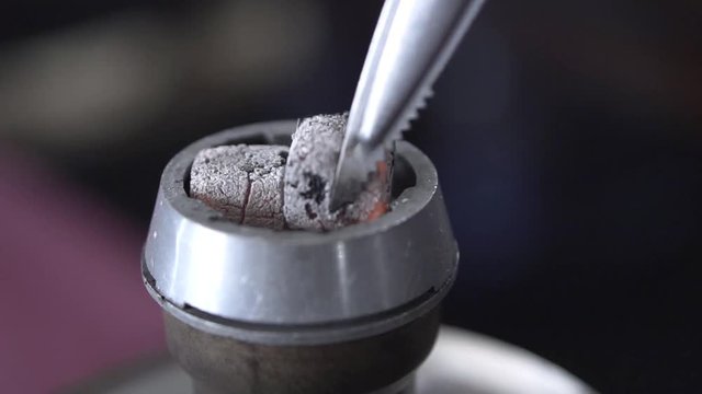Shisha hookah with red hot coals.Clip. Modern hookah with coconut charcoal for relax and shisha smoke