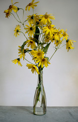 bouquet of yellow flowers in glass vase